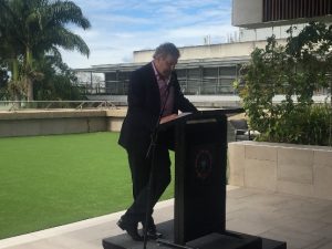 Mark Tucker-Evans at a podium speaking at Health Consumers Qld 10th birthday