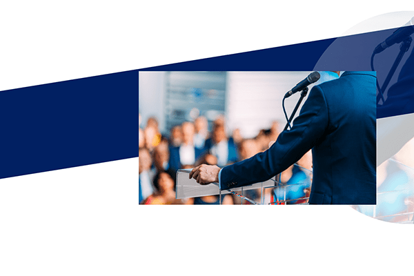 Blue strip with an image of a man talking to a crowd on a podium