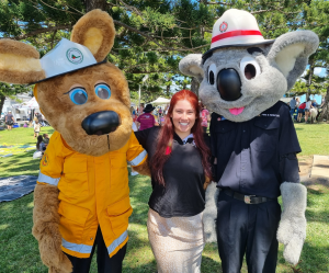 2 people dressed as bears and a lady with red hair.