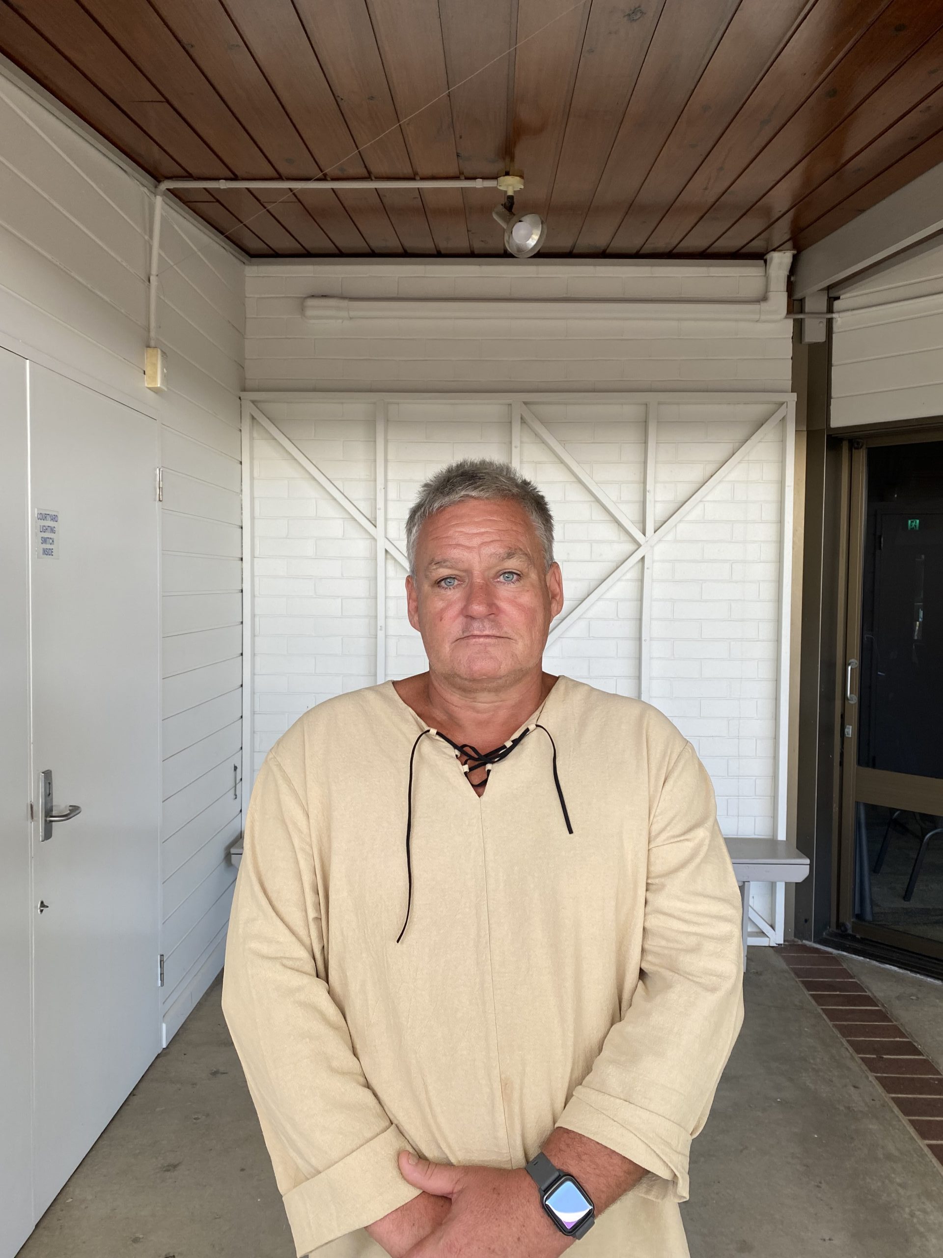 A man wearing a cream jumper looking at the camera.