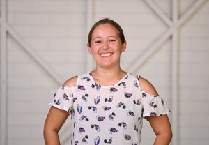 A woman smiling looking directly at the camera. 