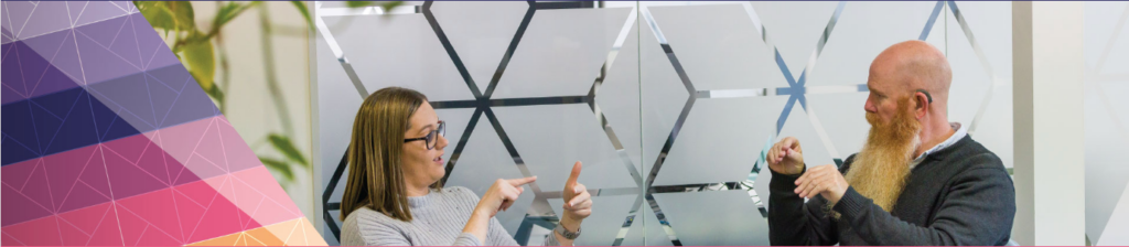 A woman and a man are having a conversation in Auslan sign language.