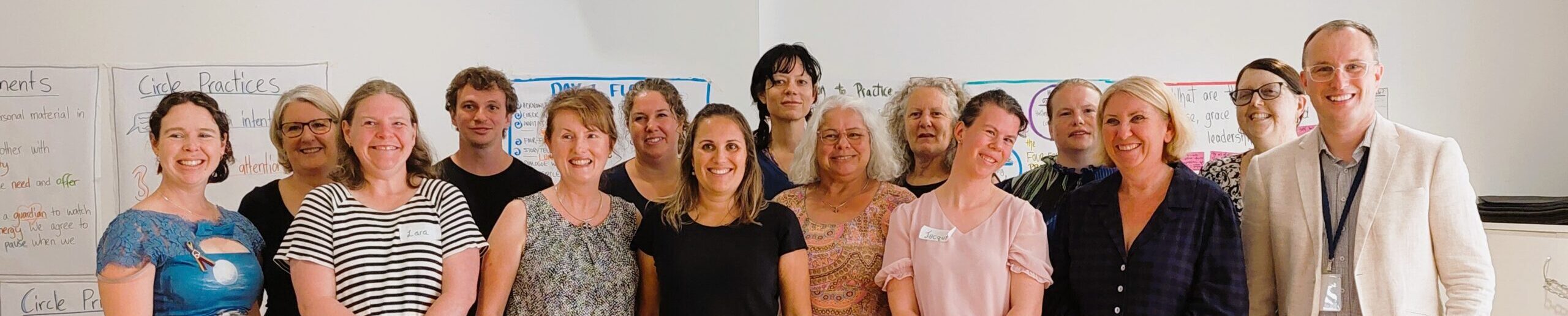 2023 Emerging leaders graduation group photo. 15 people together smiling at the camera.